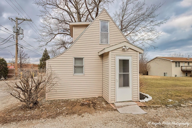 rear view of property featuring a lawn