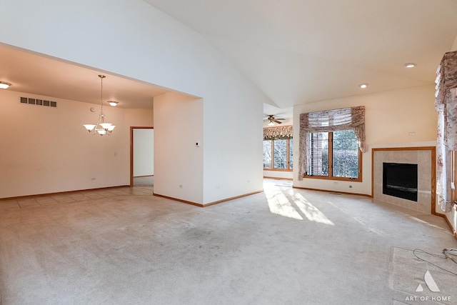 unfurnished living room with a tile fireplace, light carpet, ceiling fan with notable chandelier, and high vaulted ceiling