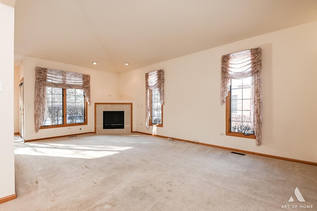 unfurnished living room with light carpet, a fireplace, and high vaulted ceiling