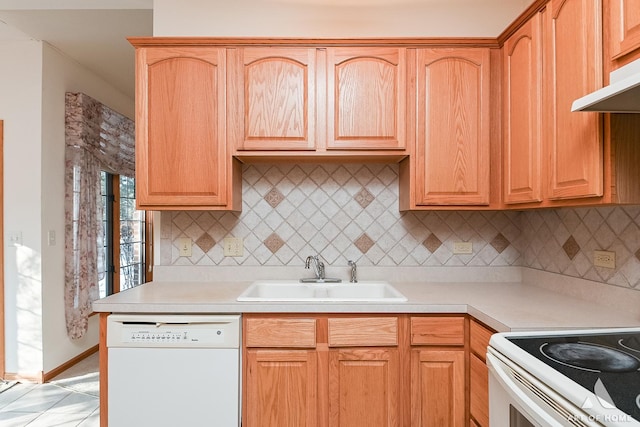 kitchen with tasteful backsplash, exhaust hood, sink, dishwasher, and light tile patterned flooring