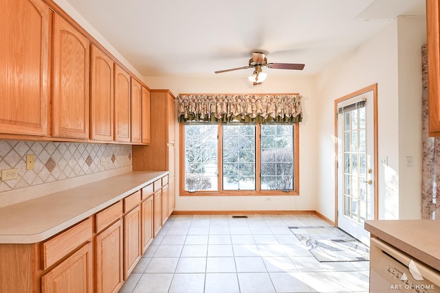 kitchen with light tile patterned floors, backsplash, white dishwasher, and ceiling fan