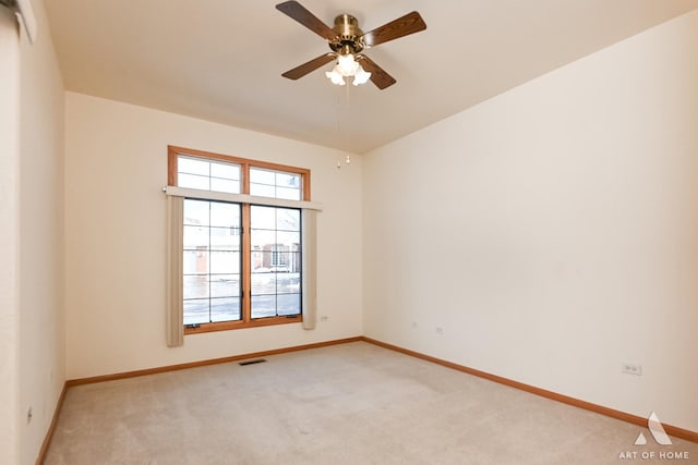 spare room with light carpet and ceiling fan