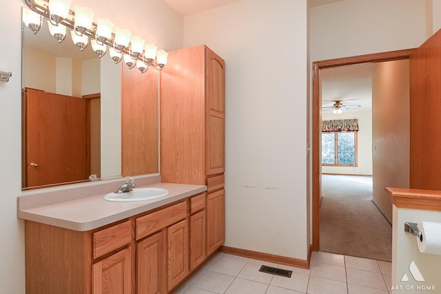 bathroom with tile patterned flooring, vanity, and ceiling fan