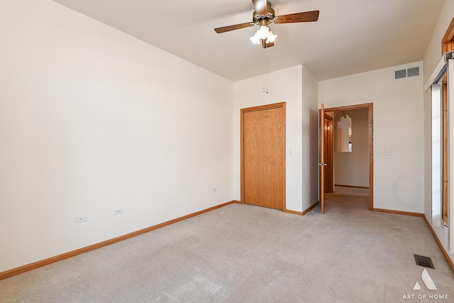 unfurnished bedroom with ceiling fan and light colored carpet