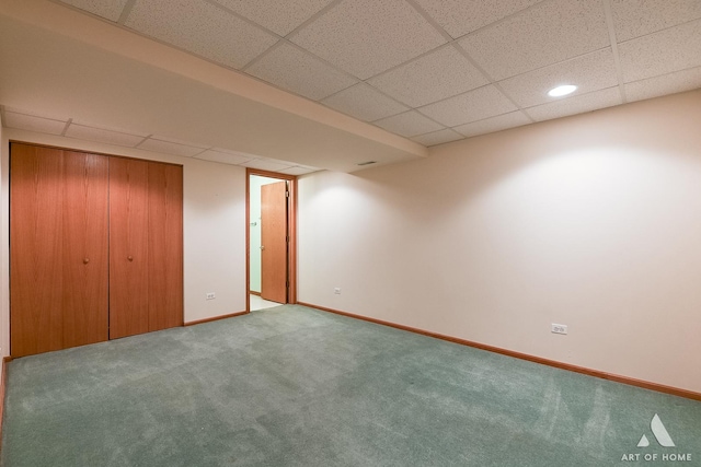 basement with a drop ceiling and carpet floors