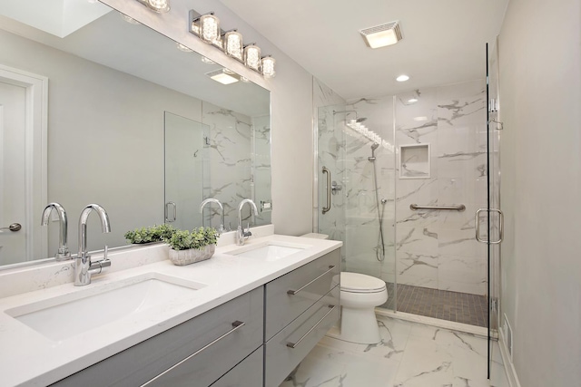 bathroom with vanity, toilet, and a shower with shower door