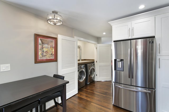 kitchen with washer and clothes dryer, dark hardwood / wood-style floors, white cabinets, and stainless steel refrigerator with ice dispenser