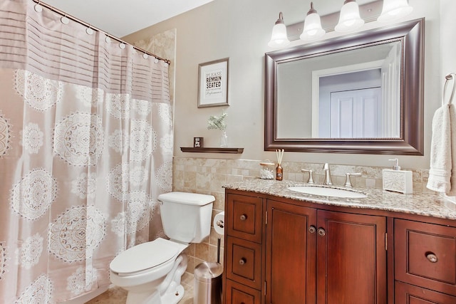 bathroom featuring tile walls, toilet, vanity, and a shower with shower curtain