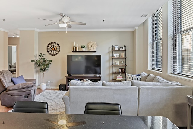 living room with ceiling fan, wood-type flooring, and crown molding