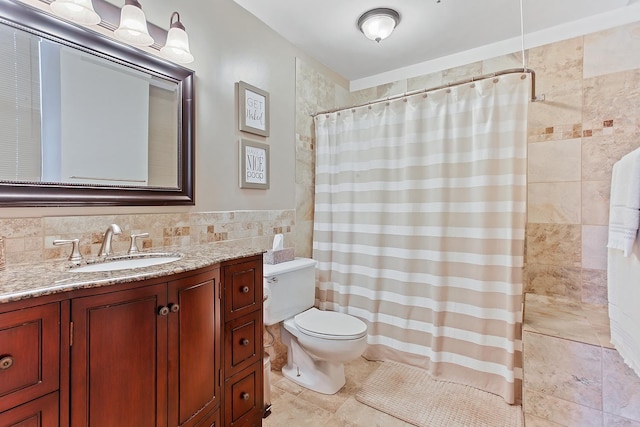 bathroom featuring toilet, vanity, tile walls, and curtained shower