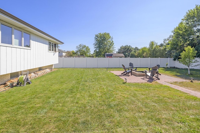 view of yard featuring a patio and a fire pit