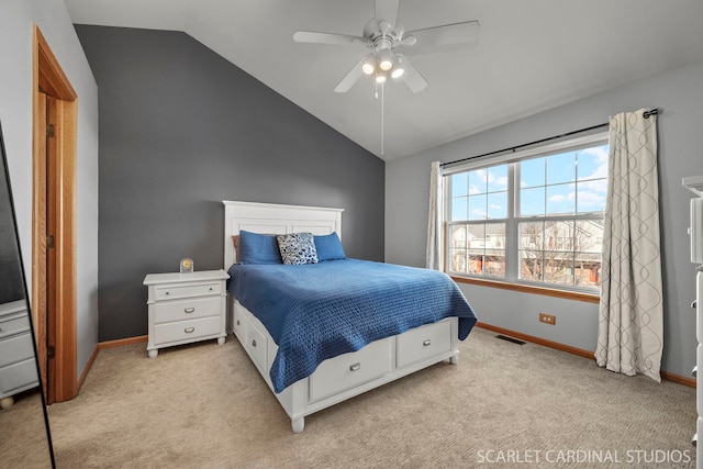 bedroom featuring vaulted ceiling, light colored carpet, and ceiling fan