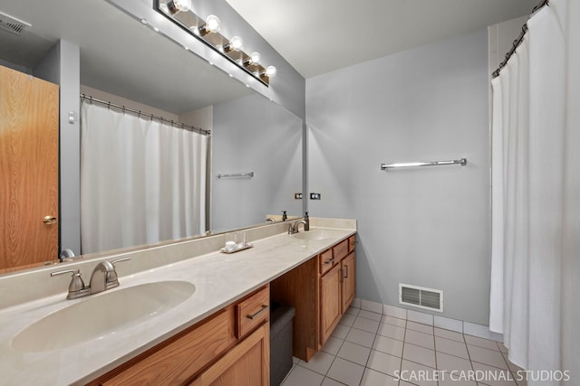 bathroom featuring tile patterned flooring and vanity