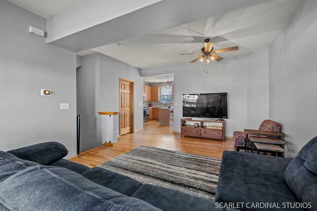 living room with ceiling fan and light wood-type flooring