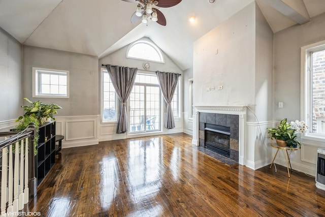 unfurnished living room with a healthy amount of sunlight, dark hardwood / wood-style flooring, and ceiling fan