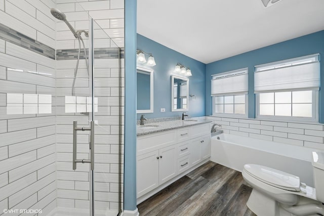 bathroom with a bath, a stall shower, and a sink