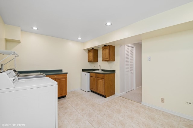 clothes washing area with laundry area, recessed lighting, a sink, and washing machine and clothes dryer