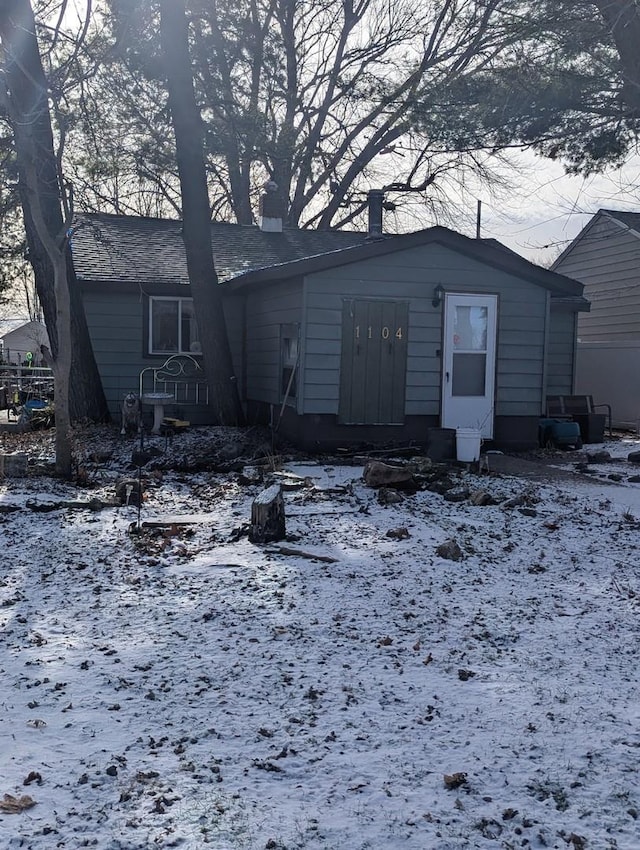 view of snow covered rear of property