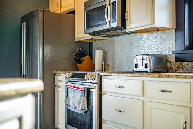 kitchen with appliances with stainless steel finishes and backsplash