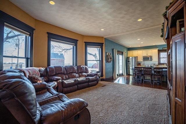 living room with vaulted ceiling and a textured ceiling