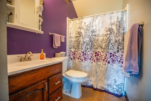 bathroom featuring vanity, tile patterned flooring, and toilet