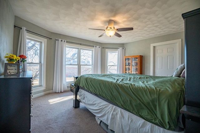 bedroom with a textured ceiling, ceiling fan, and carpet