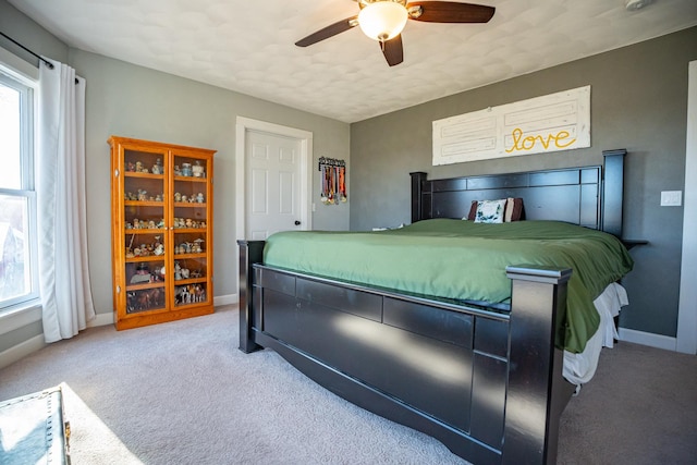 bedroom featuring ceiling fan, carpet flooring, and multiple windows