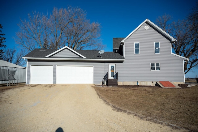 view of front of house with a garage and a front lawn