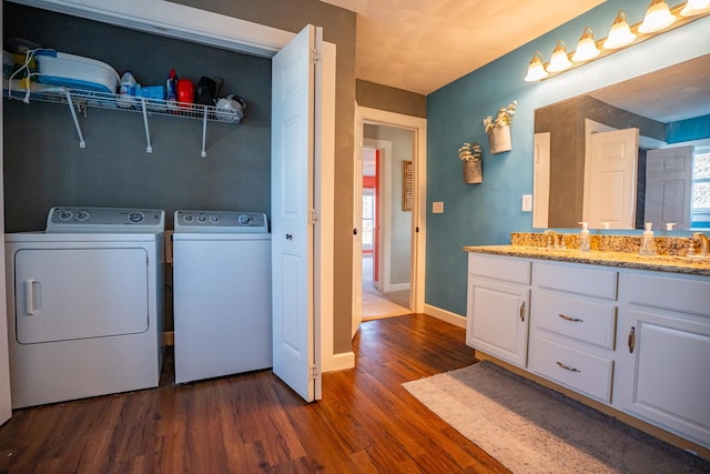 washroom featuring washer and dryer, sink, and dark hardwood / wood-style floors