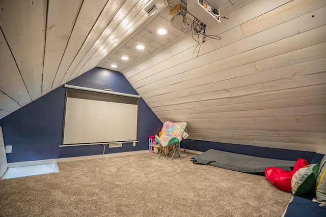 carpeted home theater with vaulted ceiling and wooden ceiling