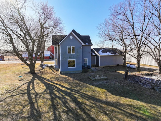 view of side of home with a yard