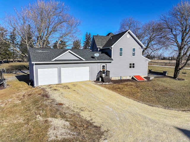 exterior space featuring a garage and a front yard