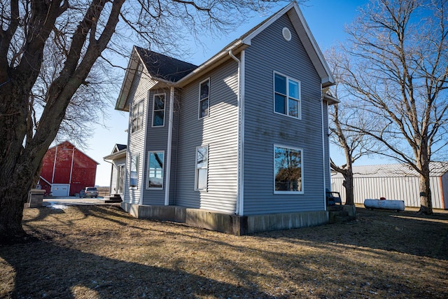 view of side of home featuring a yard