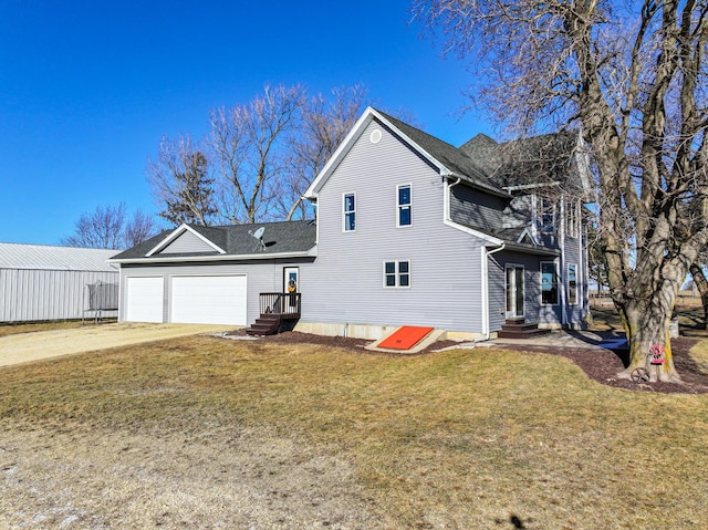 exterior space with a garage and a lawn