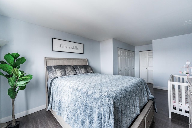 bedroom with dark hardwood / wood-style flooring