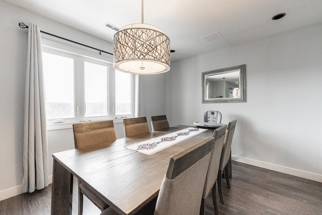 dining area featuring dark wood-type flooring