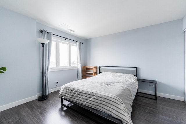 bedroom featuring dark hardwood / wood-style flooring