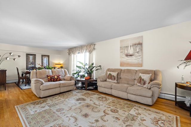 living room with a baseboard radiator and hardwood / wood-style flooring