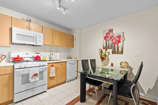 kitchen featuring light tile patterned flooring, white appliances, sink, and light brown cabinets