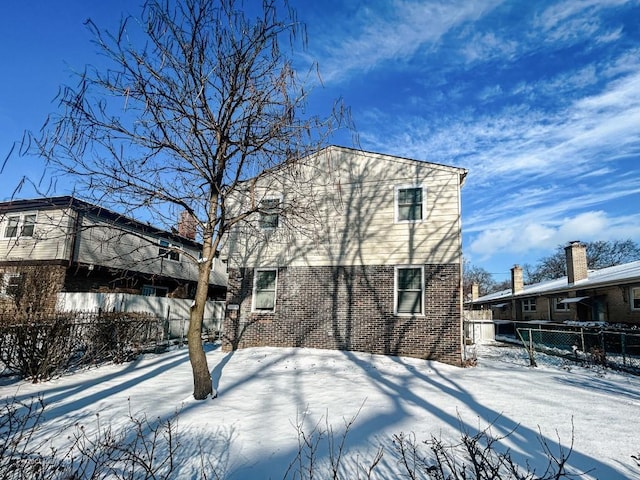 view of snow covered rear of property