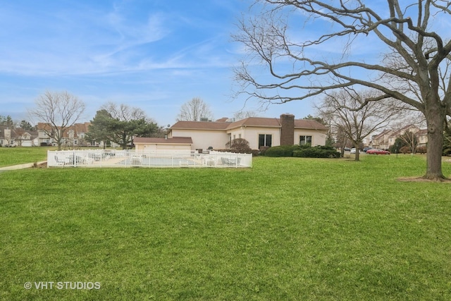 rear view of house with a yard