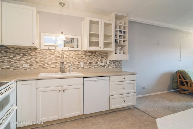 kitchen featuring white dishwasher, sink, pendant lighting, white cabinets, and range