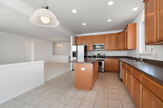 kitchen featuring pendant lighting, stainless steel appliances, a notable chandelier, a kitchen island, and sink