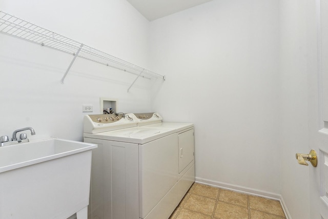 washroom with sink and washing machine and clothes dryer