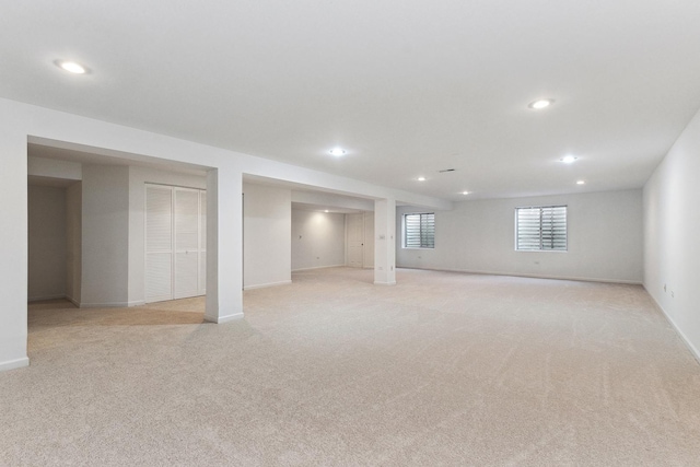 basement featuring light colored carpet