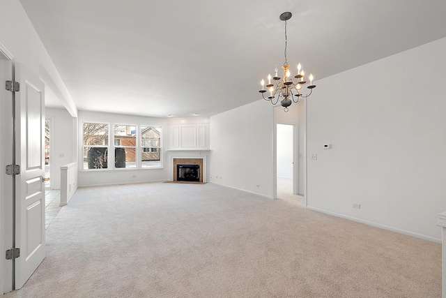 unfurnished living room with light carpet and a notable chandelier