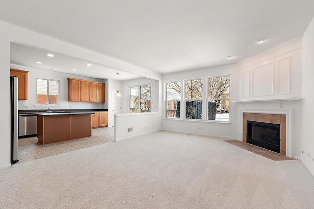 unfurnished living room featuring light colored carpet