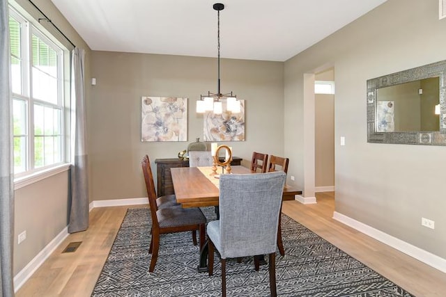 dining space with hardwood / wood-style flooring