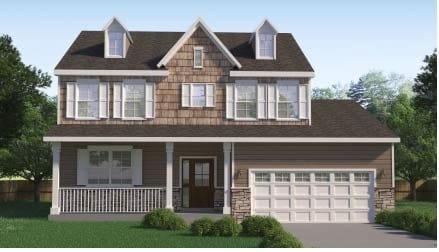 view of front of house with a garage, covered porch, and a front yard