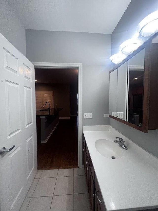 bathroom featuring tile patterned flooring and vanity